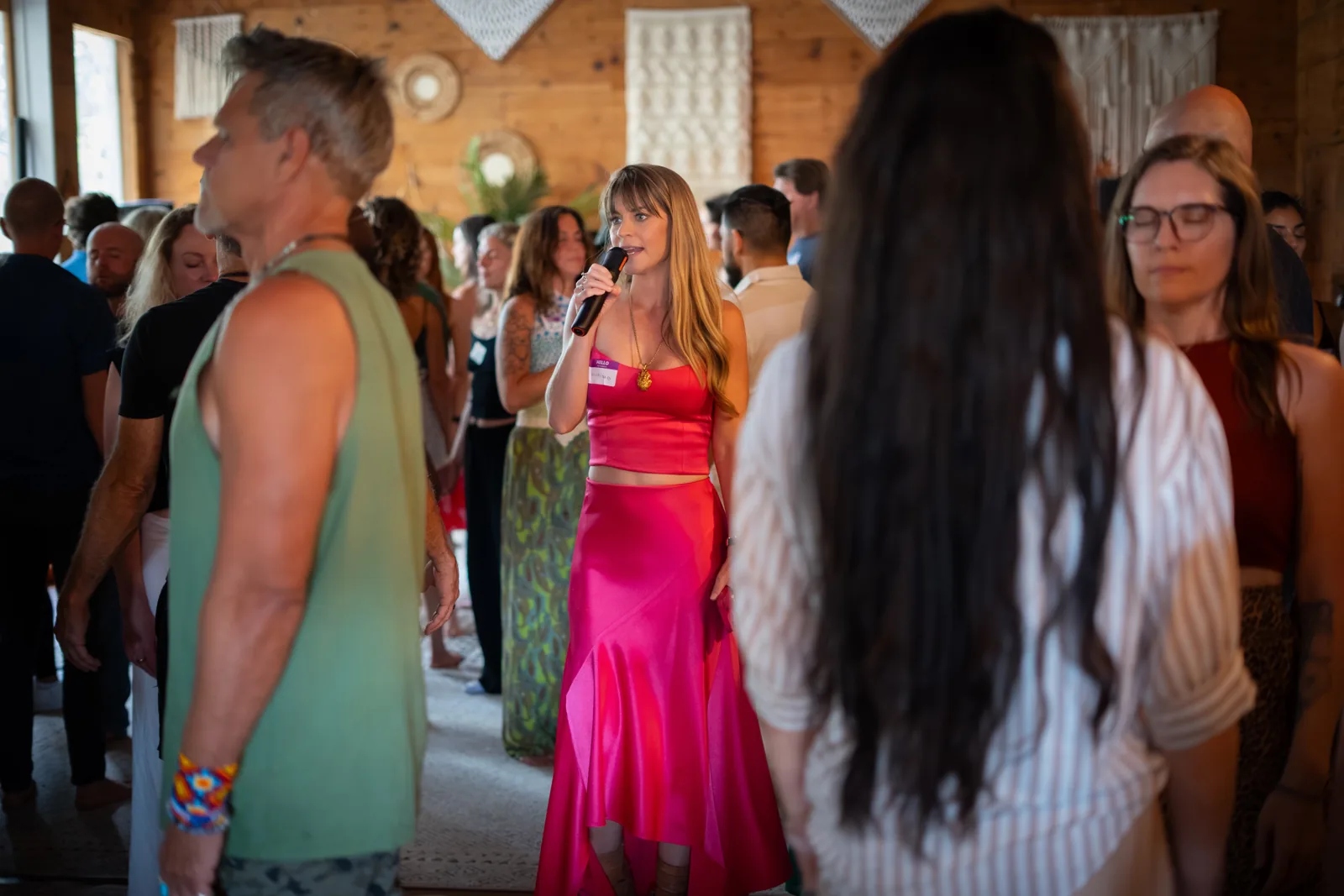 Christina Weber on the mic, walking through the room at a WeDeepen event