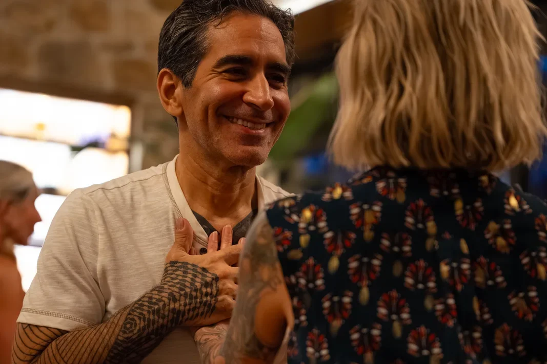 René Besson smiling with a hand on his heart during a partner practice at Love Immersion