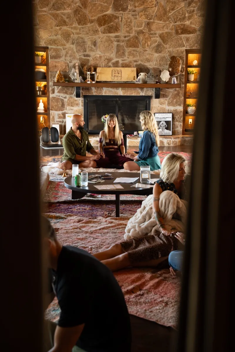 The opening circle gathered by the fireplace at a Love Immersion